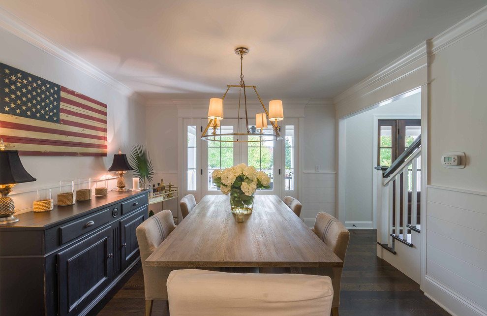 Example of a mid-sized island style dark wood floor, brown floor, wallpaper ceiling and wallpaper enclosed dining room design in Chicago with white walls and no fireplace