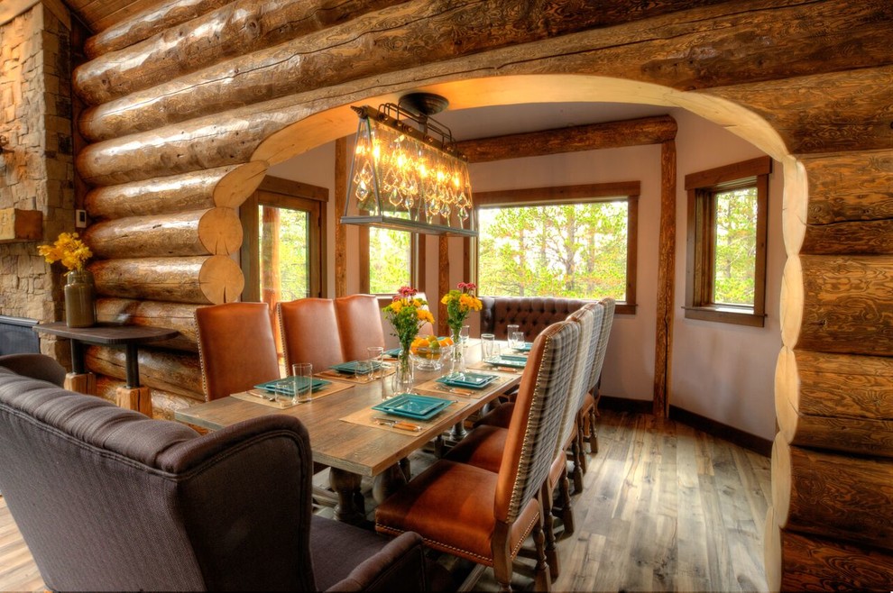 Foto di una sala da pranzo aperta verso il soggiorno rustica di medie dimensioni con pavimento in legno massello medio, pavimento grigio, pareti beige e nessun camino
