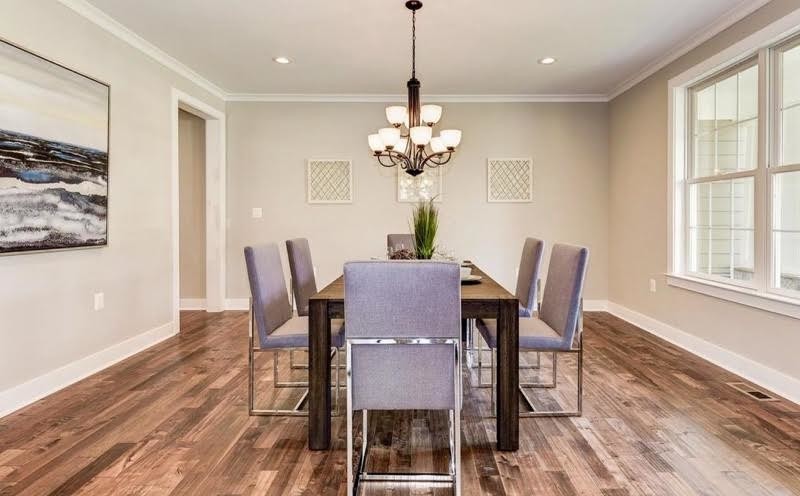 Inspiration for a medium sized contemporary enclosed dining room in DC Metro with beige walls, medium hardwood flooring and brown floors.