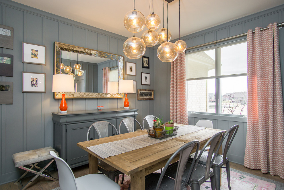 Inspiration for a medium sized classic enclosed dining room in Chicago with grey walls, light hardwood flooring, no fireplace and feature lighting.