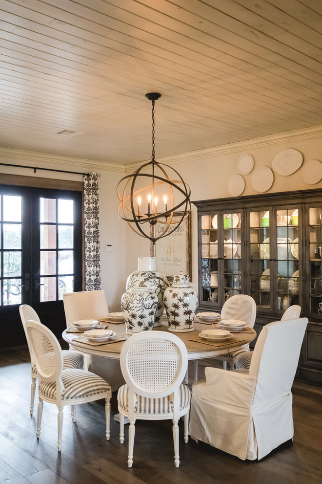 Medium sized country dining room in Oklahoma City with white walls and medium hardwood flooring.