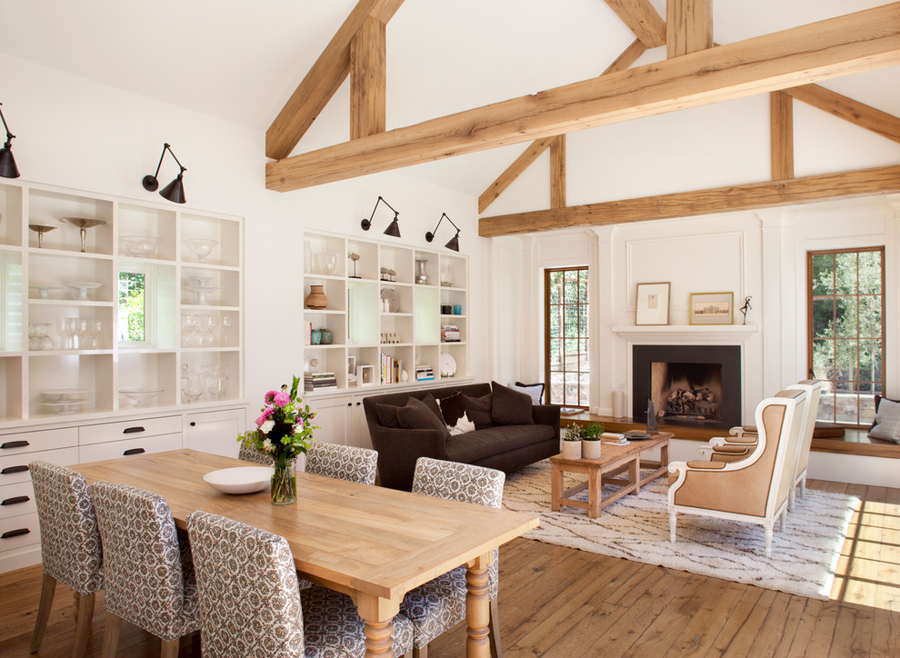 Inspiration for a large country medium tone wood floor great room remodel in Other with white walls