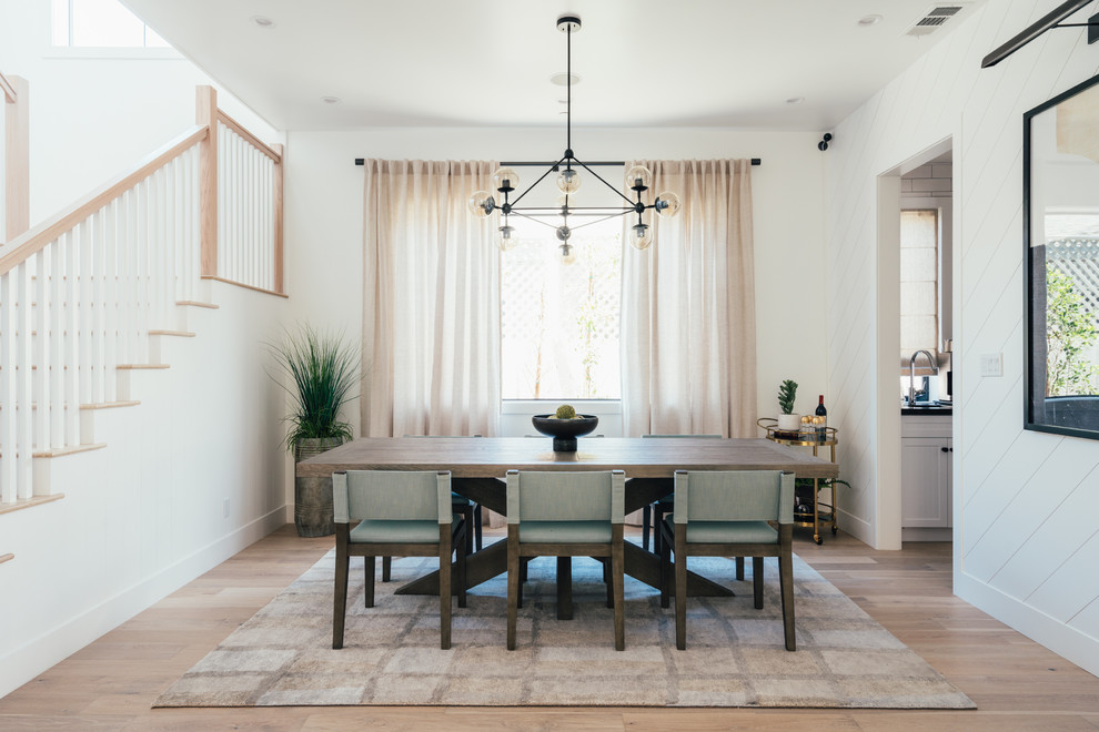 Example of a country light wood floor dining room design in Los Angeles with white walls and no fireplace