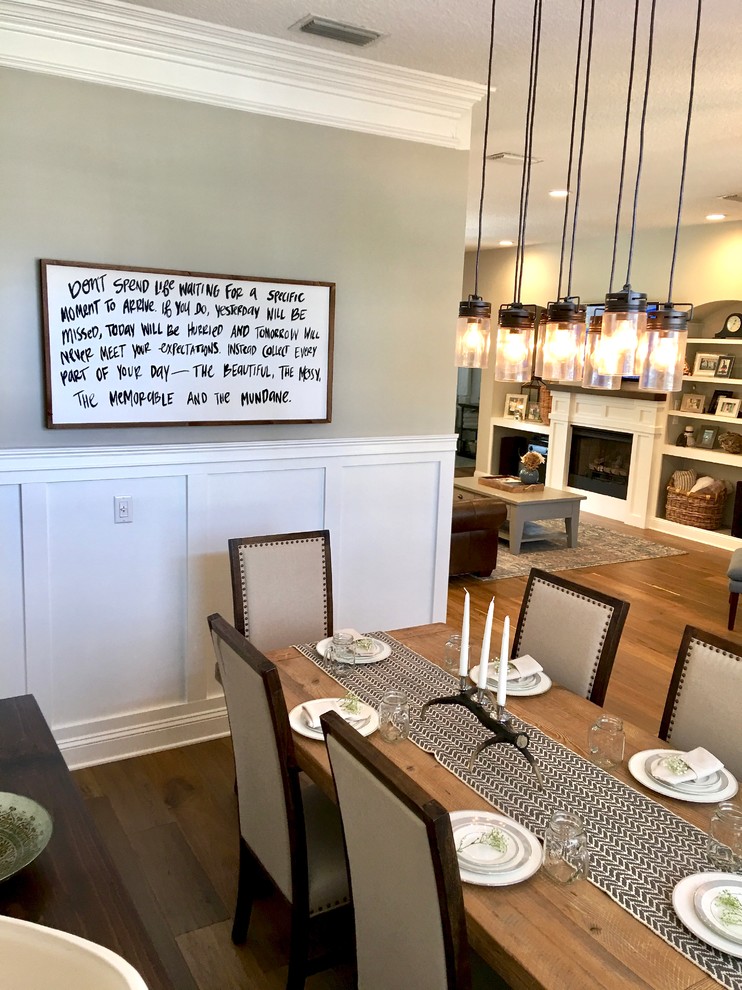 Design ideas for a medium sized farmhouse enclosed dining room in Jacksonville with grey walls and medium hardwood flooring.