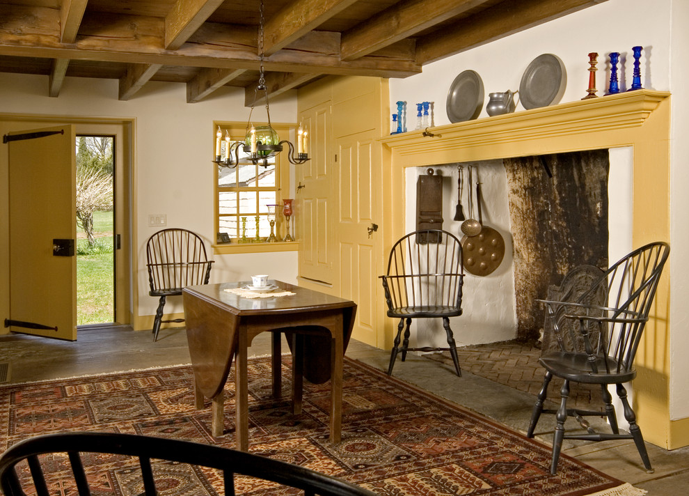 Farmhouse dining room photo in Philadelphia with white walls and a standard fireplace