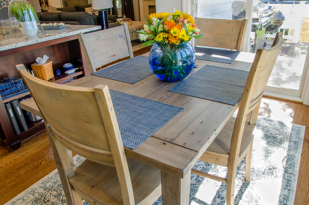 Ispirazione per una piccola sala da pranzo aperta verso la cucina country con pareti grigie e pavimento in legno massello medio