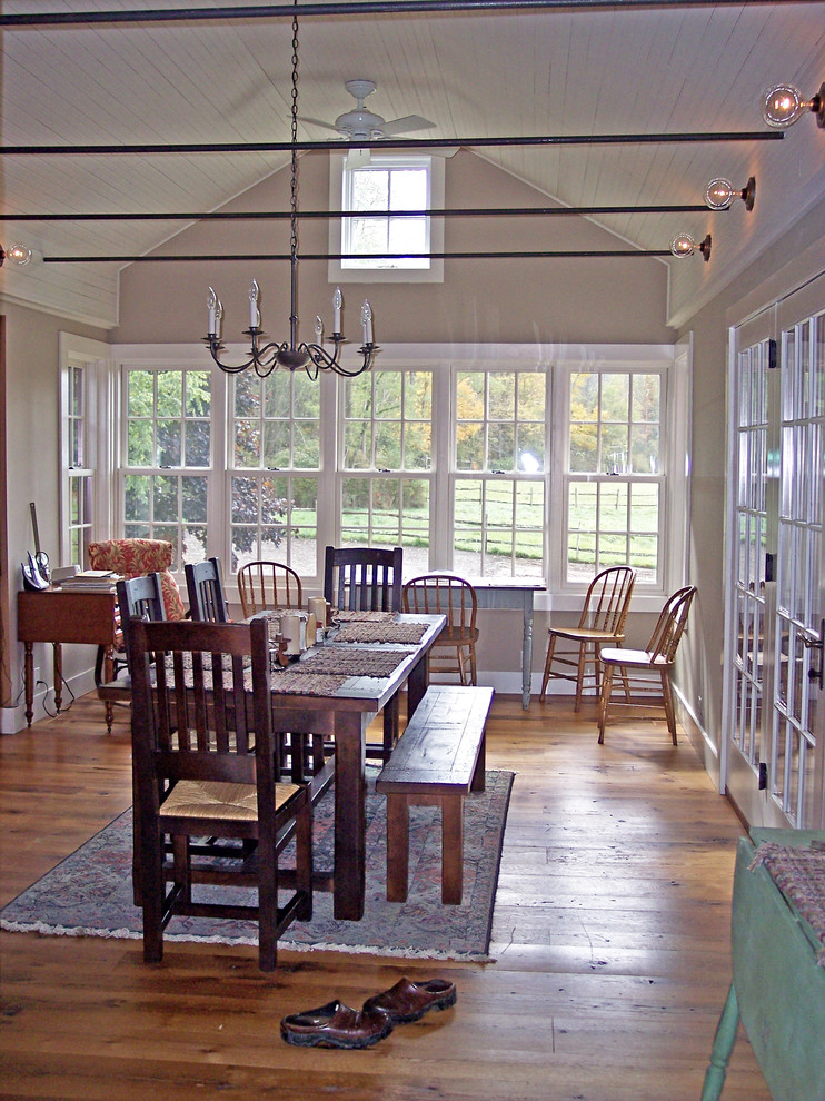 Photo of a farmhouse open plan dining room in Burlington with beige walls and medium hardwood flooring.