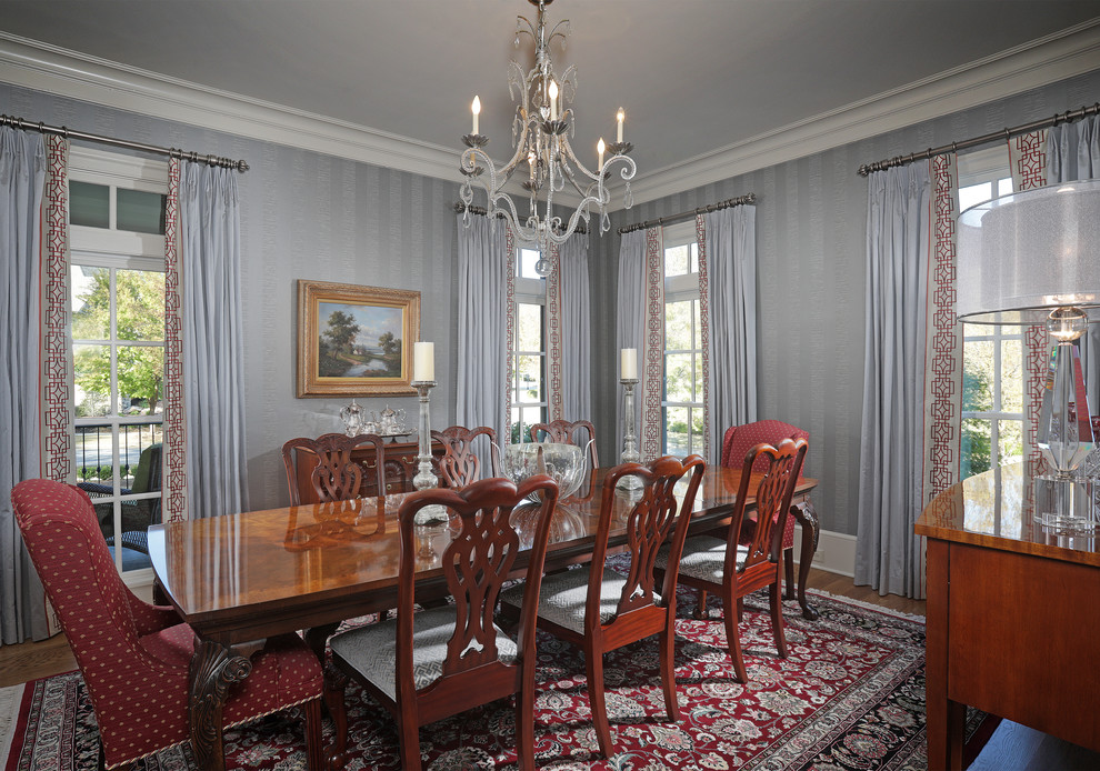 Mid-sized elegant medium tone wood floor enclosed dining room photo in Atlanta with gray walls and no fireplace
