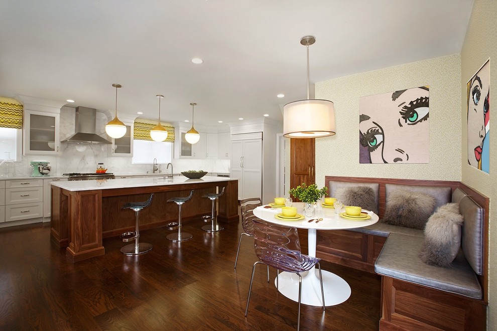 Large classic kitchen/dining room in New York with dark hardwood flooring.