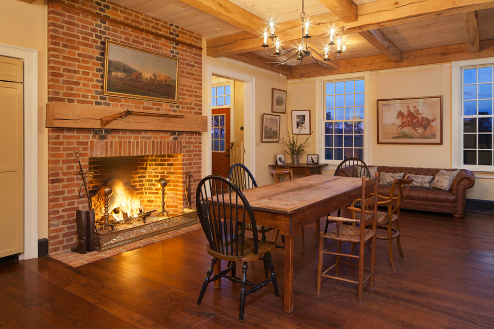 Great room - large country dark wood floor great room idea in Baltimore with a standard fireplace, a brick fireplace and yellow walls