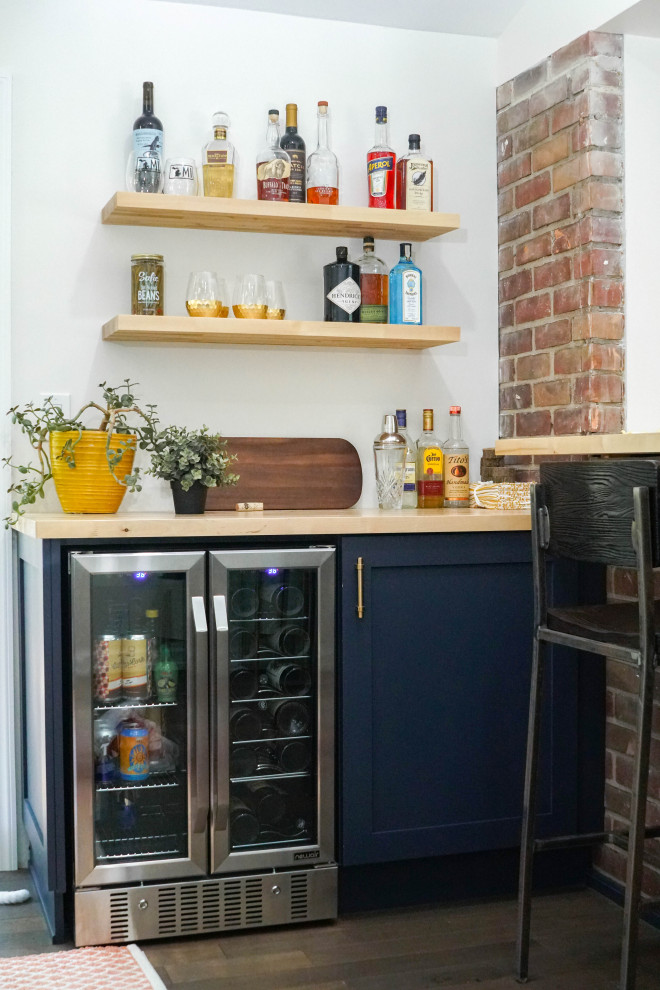 Example of a small eclectic brown floor home bar design in Detroit
