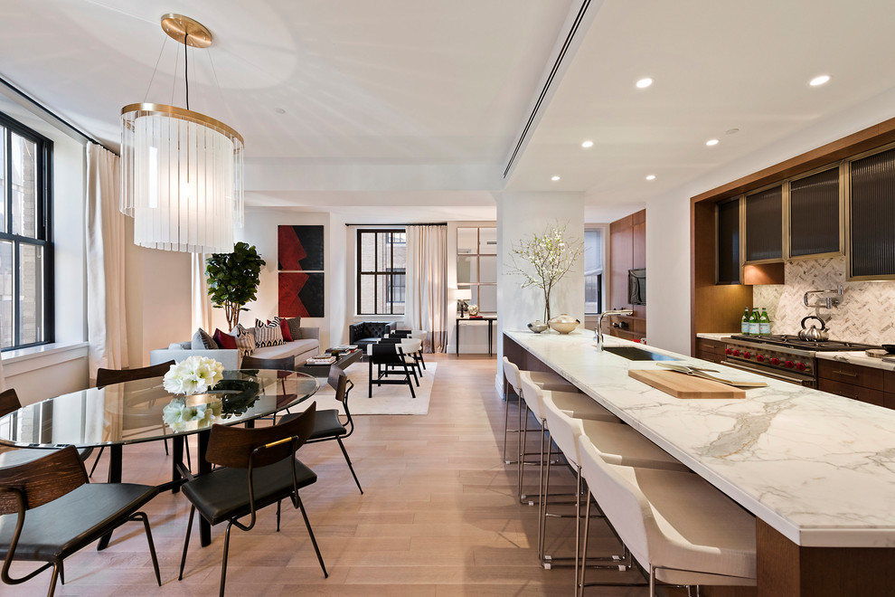 Medium sized modern open plan dining room in New York with white walls, light hardwood flooring, no fireplace and brown floors.