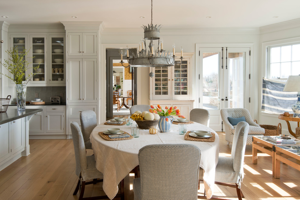 Photo of a traditional kitchen/dining room in New York with white walls and medium hardwood flooring.