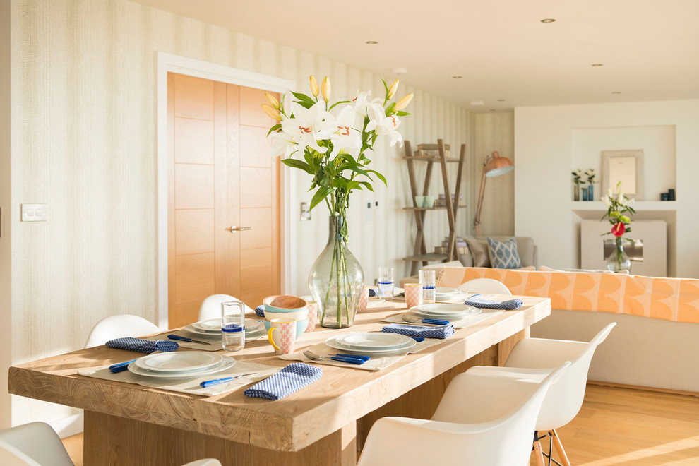 Design ideas for a classic open plan dining room in Cornwall with beige walls and light hardwood flooring.