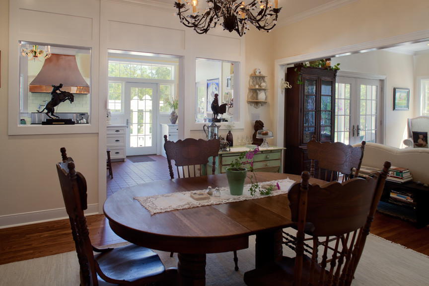 Medium sized country open plan dining room in Austin with beige walls, medium hardwood flooring and no fireplace.