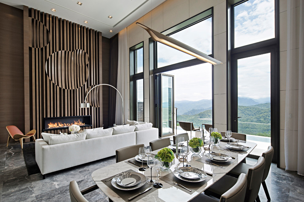 Réalisation d'une salle à manger ouverte sur le salon design avec un mur beige, une cheminée ribbon, un manteau de cheminée en bois et un sol gris.