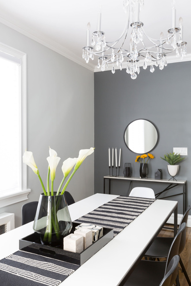 Example of a trendy medium tone wood floor dining room design in New York with gray walls and no fireplace