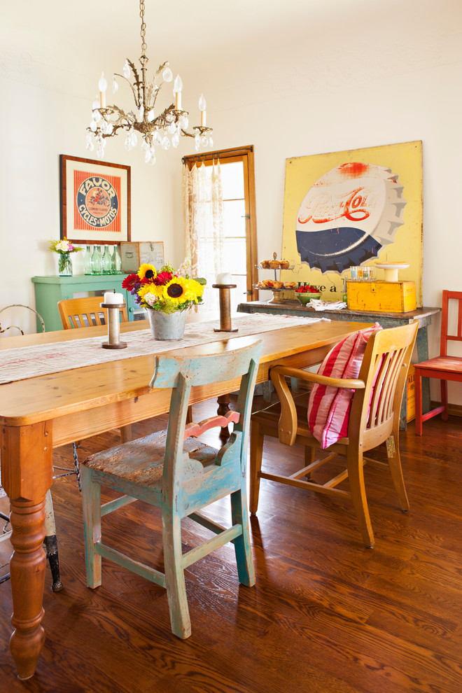 Inspiration for a shabby-chic style medium tone wood floor enclosed dining room remodel in Los Angeles with white walls