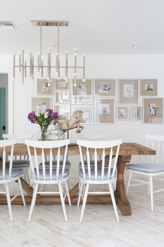Dining room - mid-sized coastal light wood floor and beige floor dining room idea in Miami with white walls and no fireplace