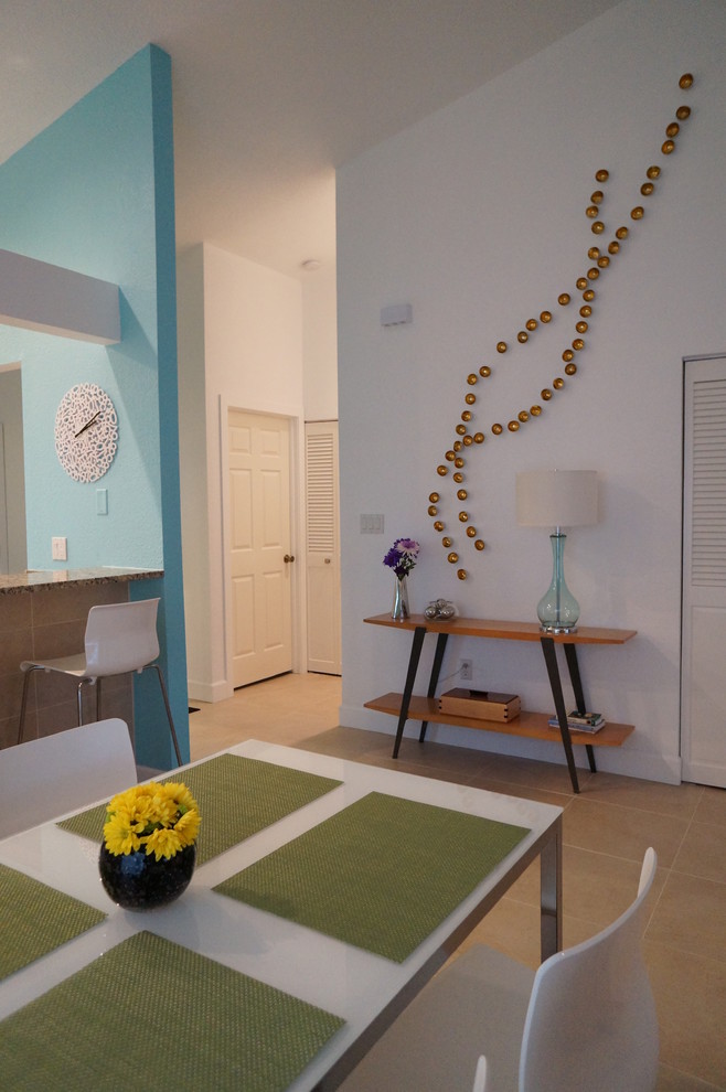 Idée de décoration pour une salle à manger ouverte sur le salon design de taille moyenne avec un mur bleu, un sol en carrelage de porcelaine et aucune cheminée.