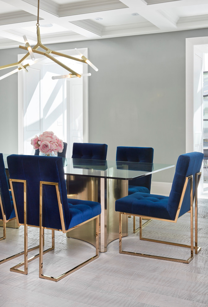 Immagine di una grande sala da pranzo minimal chiusa con pareti blu e parquet chiaro