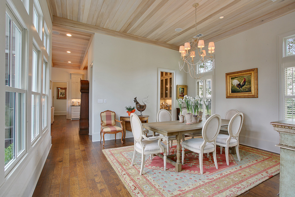 Example of a mid-sized french country dark wood floor enclosed dining room design in New Orleans with white walls and no fireplace