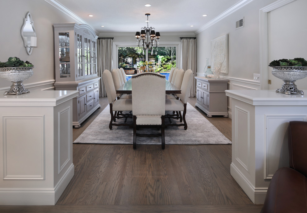 Example of a large transitional medium tone wood floor and brown floor dining room design in Orange County with beige walls and no fireplace