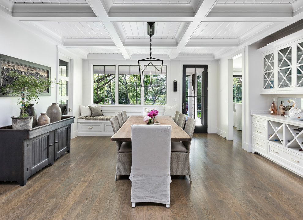 Inspiration for a large coastal medium tone wood floor dining room remodel in Detroit with no fireplace and white walls