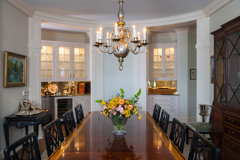 Inspiration for a huge timeless medium tone wood floor enclosed dining room remodel in Chicago with white walls