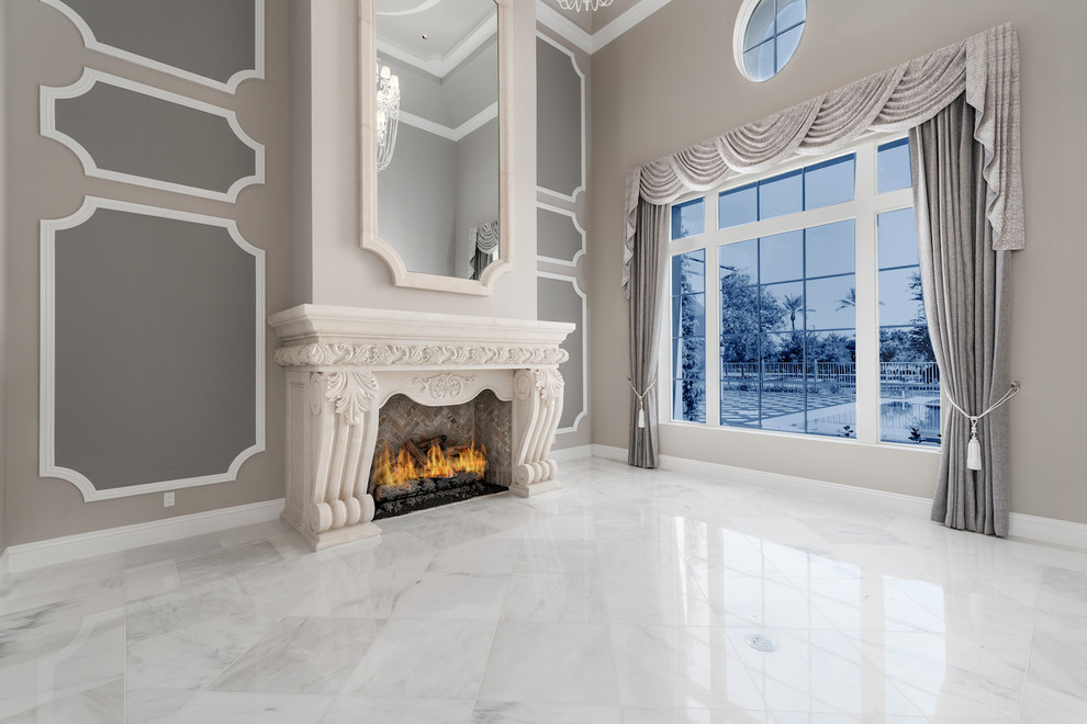 Inspiration for a huge mediterranean formal and open concept marble floor, multicolored floor, coffered ceiling and wall paneling living room remodel in Phoenix with beige walls, a standard fireplace, a stone fireplace and a wall-mounted tv