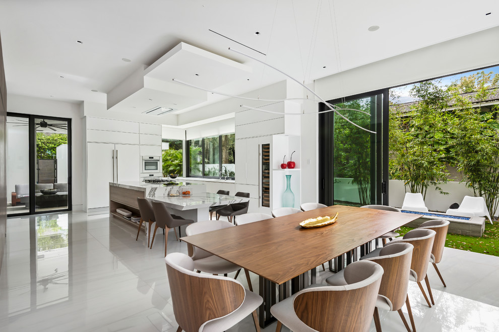 Inspiration for a contemporary kitchen/dining room in Orlando with white walls, no fireplace and white floors.