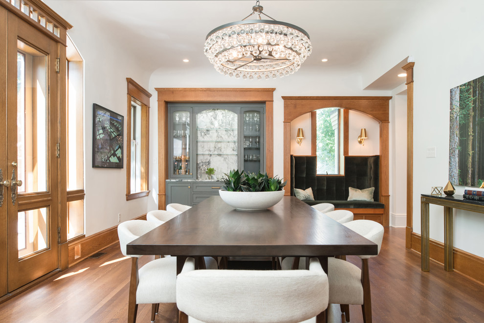 Inspiration for a large timeless medium tone wood floor dining room remodel in Kansas City with white walls