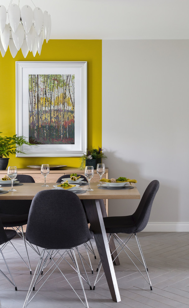 Modern inredning av ett kök med matplats, med klinkergolv i porslin, grått golv och gula väggar