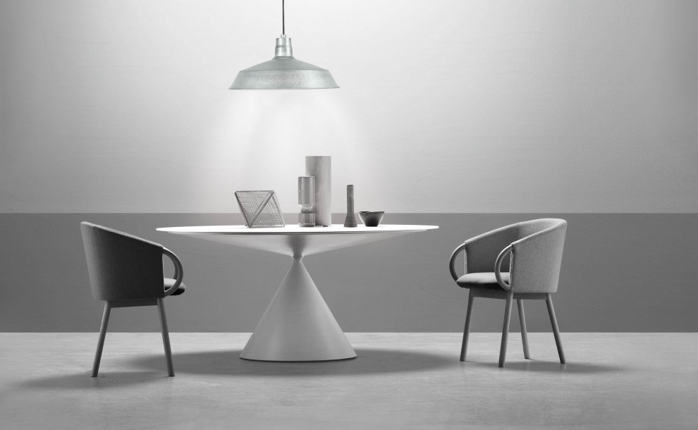 Cette image montre une salle à manger minimaliste de taille moyenne avec une banquette d'angle, un mur gris, sol en béton ciré, aucune cheminée et un sol gris.