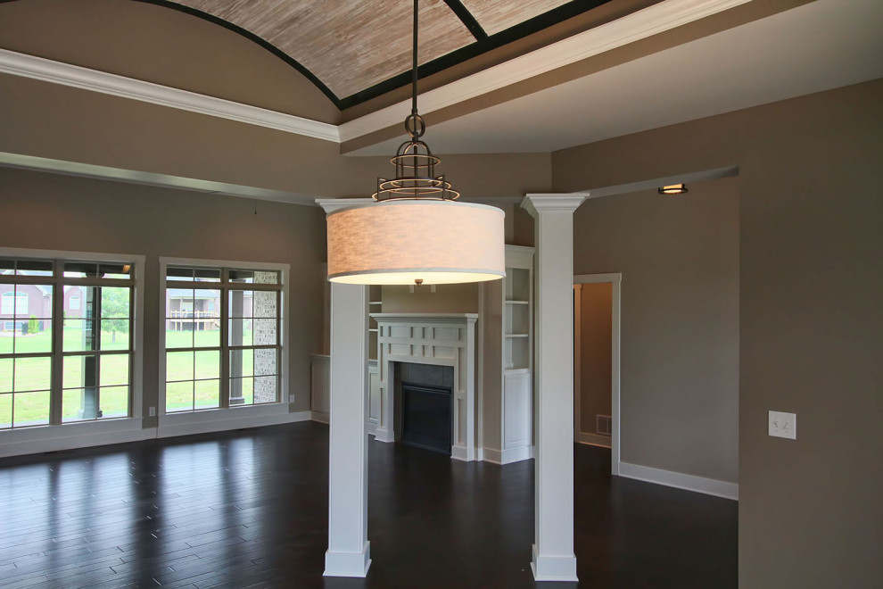 This is an example of a rustic open plan dining room in Louisville with beige walls, dark hardwood flooring, brown floors and a vaulted ceiling.