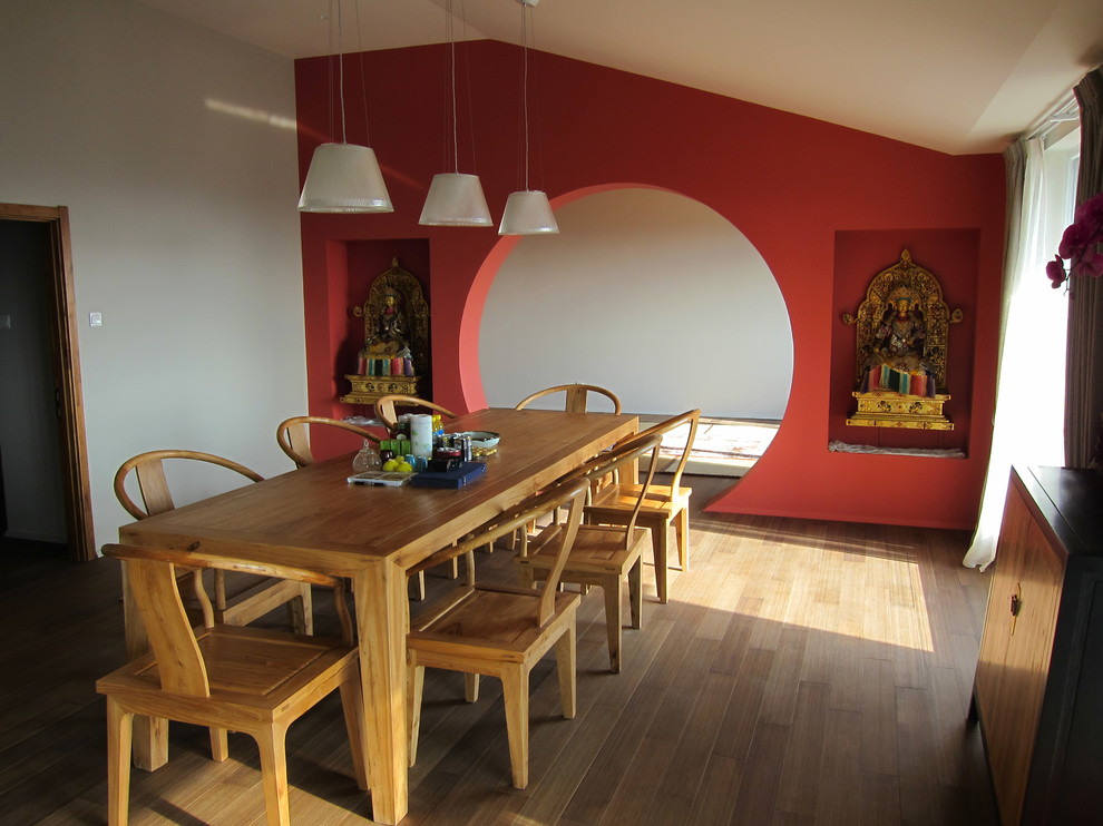 Foto på en stor orientalisk matplats, med mellanmörkt trägolv, flerfärgade väggar och brunt golv