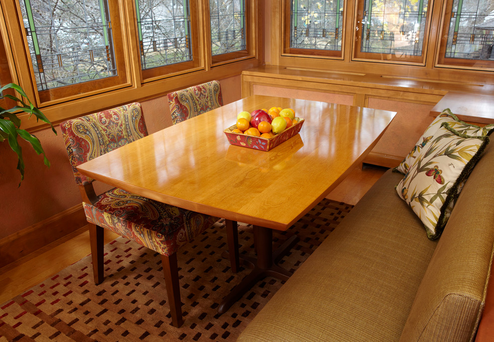 Mid-sized mid-century modern light wood floor enclosed dining room photo in Chicago with brown walls and no fireplace