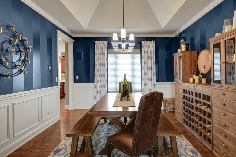 Large classic enclosed dining room in Chicago with blue walls, medium hardwood flooring, no fireplace and brown floors.