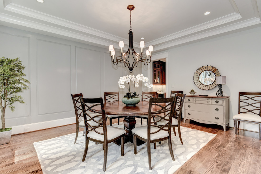 Medium sized traditional enclosed dining room in DC Metro with grey walls, dark hardwood flooring, no fireplace and brown floors.