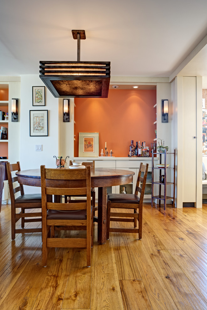 Small contemporary open plan dining room in San Francisco with white walls, medium hardwood flooring and yellow floors.