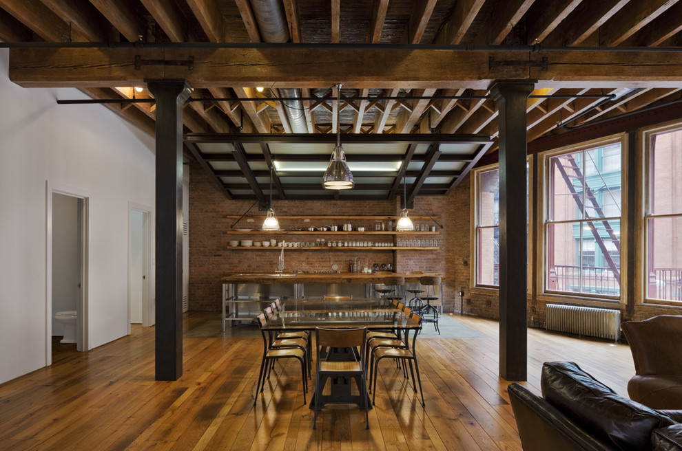 Great room - mid-sized industrial medium tone wood floor great room idea in New York with multicolored walls