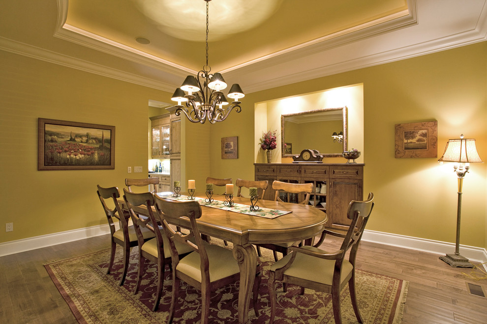 Photo of a large classic enclosed dining room in Vancouver with beige walls and medium hardwood flooring.