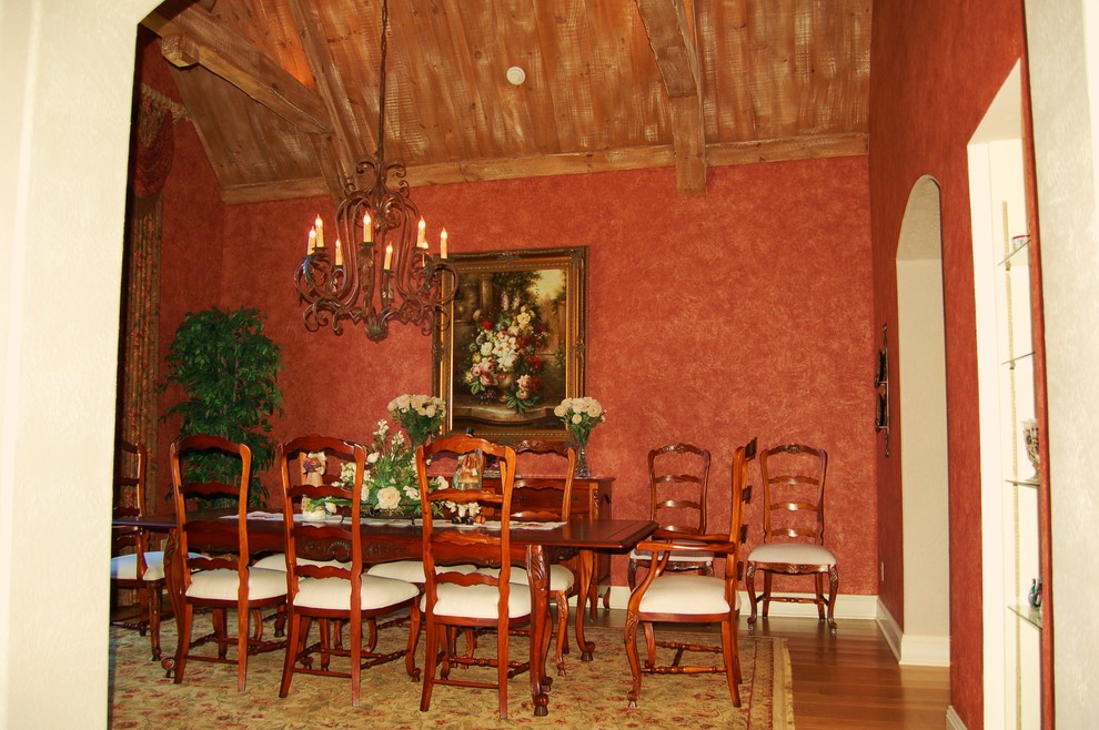 Large tuscan enclosed dining room photo in Other with red walls