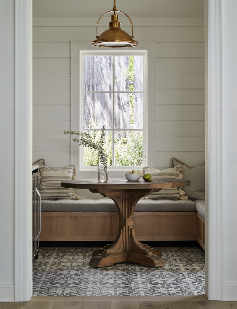 Inspiration for a farmhouse multicolored floor dining room remodel in New York with white walls