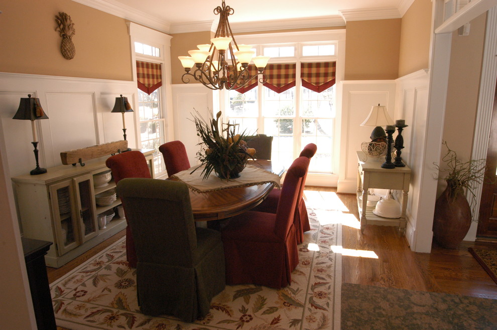 Example of a mid-sized classic medium tone wood floor enclosed dining room design in Atlanta with beige walls and no fireplace