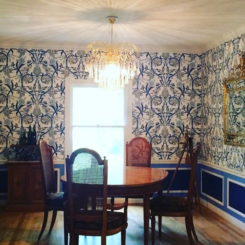 Photo of a medium sized bohemian enclosed dining room in Milwaukee with blue walls, light hardwood flooring, no fireplace and brown floors.