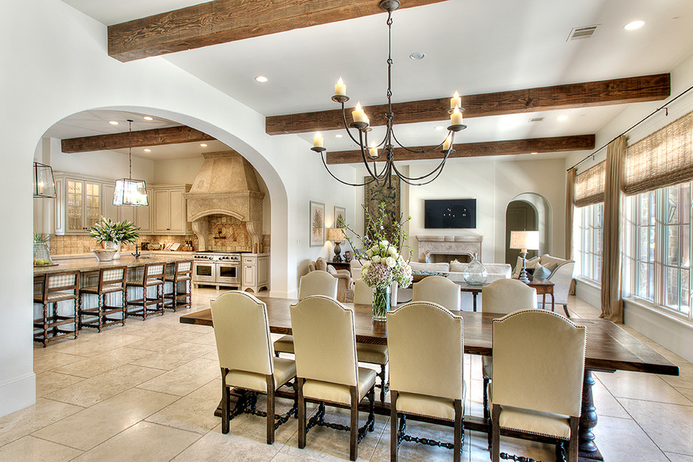 Dining room - traditional dining room idea in Houston with white walls and a standard fireplace