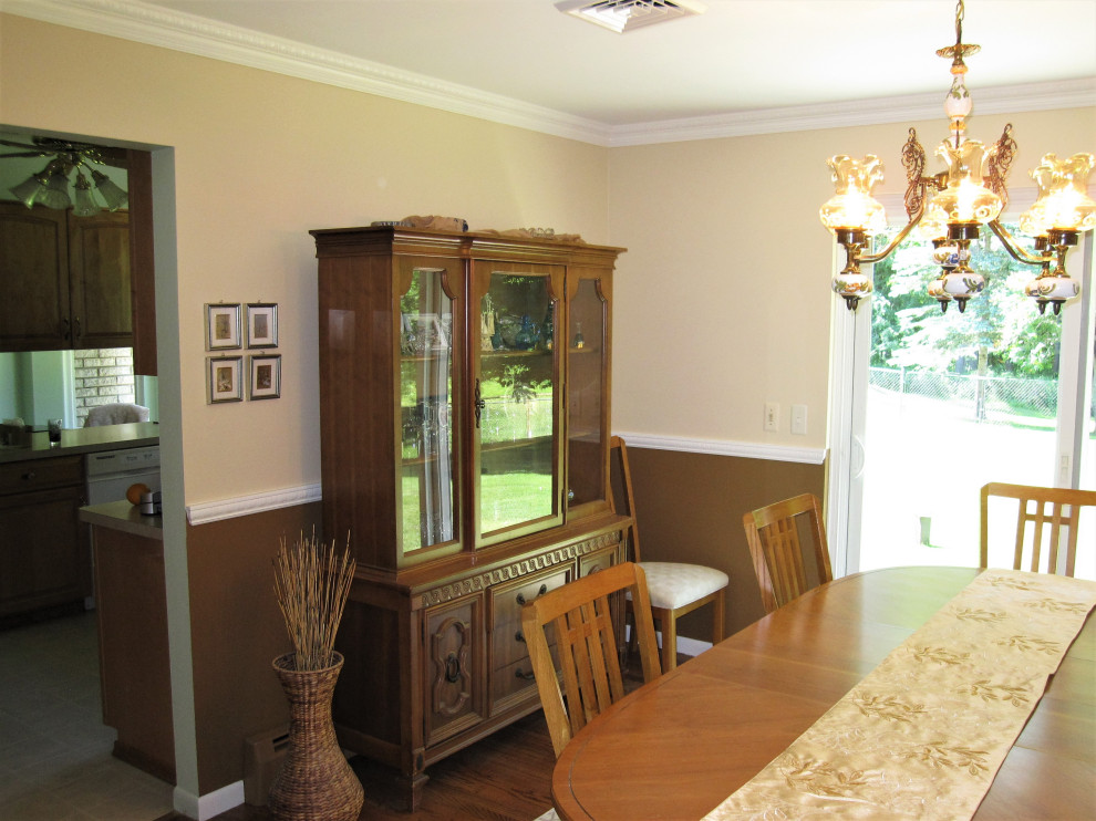 Example of a mid-sized classic dark wood floor and brown floor dining room design in Detroit with beige walls and no fireplace