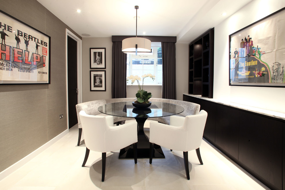 This is an example of a contemporary enclosed dining room in London with white walls.