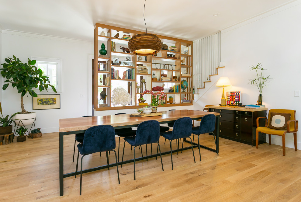 Inspiration for a large contemporary medium tone wood floor and brown floor dining room remodel in Charleston with white walls